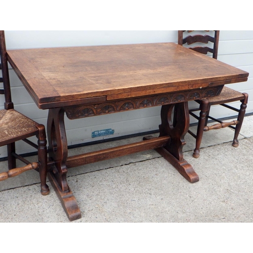 619 - An oak draw leaf dining table together with 6 (5+1) rush seated chairs (7)