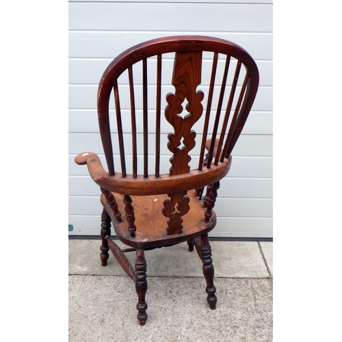 636 - A Victorian pad arm Windsor chair, with later strengthening bars