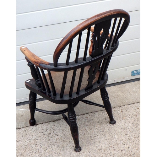 637 - A 19th cen dark stained, low backed Windsor chair with crinoline stretcher