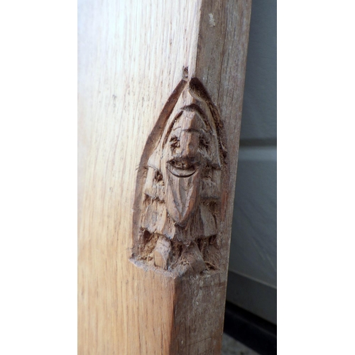 645 - A Gnome motif, rosette carved three panel oak board, 92x45cm