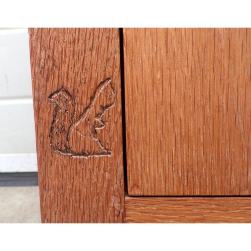 646 - An oak bedside cabinet with squirrel motif, 46cm wide