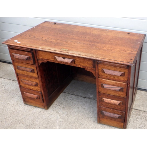 652 - A 1930's oak office desk, missing roll top, 122cm wide