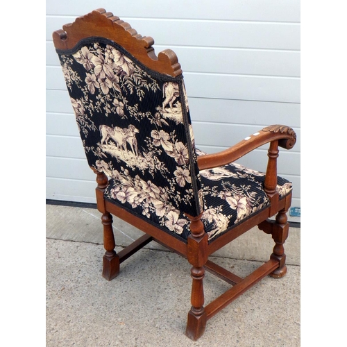 654 - A 1930's carved oak upholstered armchair