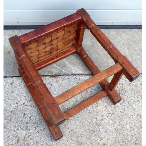 657 - An oak stool with latice leather seat, in the manner of Thompson, 39cm wide