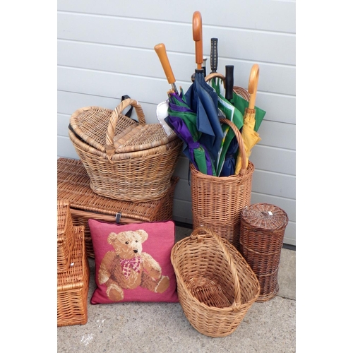 676 - A wicker stick stand with sticks and umbrellas, further baskets and hampers incl Fortnum & Mason  et... 