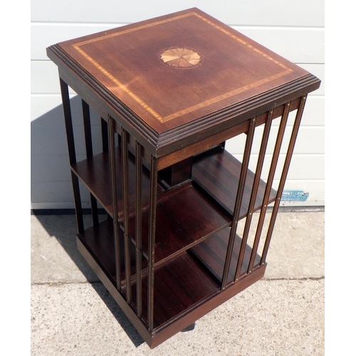 714 - A reproduction mahogany and fan inlaid revolving bookcase