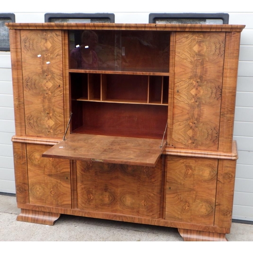 735 - A Continental 1930's burr walnut two section side cabinet with central drop down bar, in the manner ... 