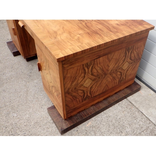 738 - A 1930's Continental crossbanded walnut desk with shelved back on a rosewood base, 162cm wide incl p... 