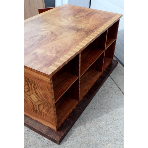 738 - A 1930's Continental crossbanded walnut desk with shelved back on a rosewood base, 162cm wide incl p... 