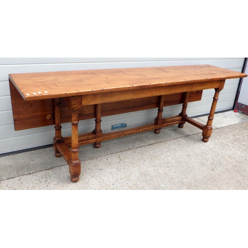 776 - A solid oak drop leaf refectory table 213cm (7ft) long x 91cm (3ft) wide, hinged along its long axis... 