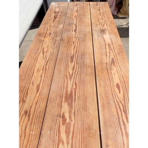 785 - A long pitch pine drapers table on turned legs, 205cm long, 84cm across