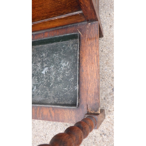 816 - A 1930's oak hall seat/stick stand, a/c cracked front together with an ashtray stand (2)