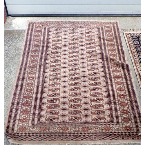 833 - A beige ground runner & two further rugs (3)