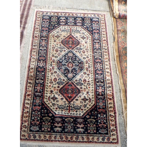 833 - A beige ground runner & two further rugs (3)