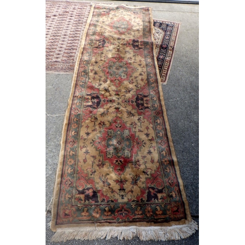 833 - A beige ground runner & two further rugs (3)