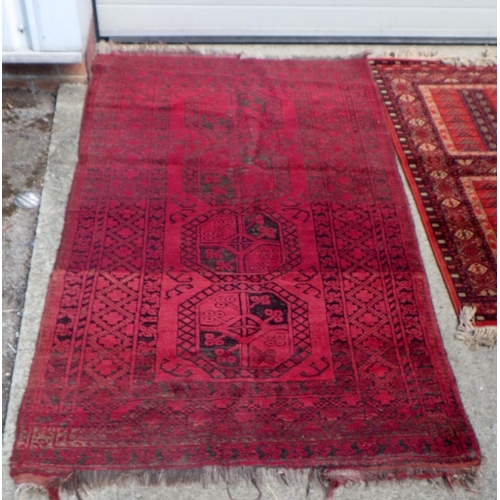 834 - Three red ground rugs