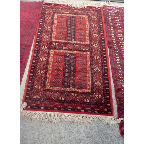 834 - Three red ground rugs