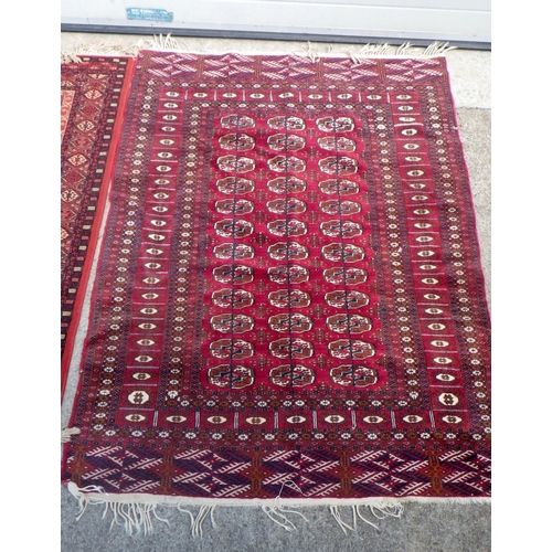 834 - Three red ground rugs