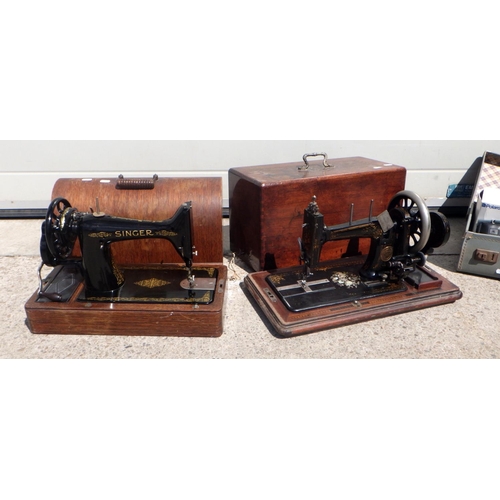 835 - Two cased sewing machines, a grey suitcase & cameras