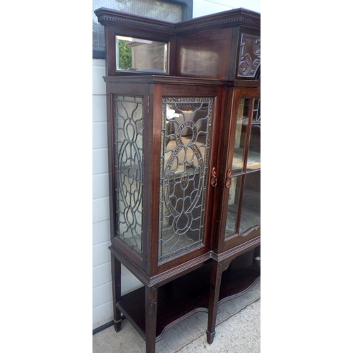 840 - An Edwardian mahogany display cabinet with leaded glass doors. 138cm wide.