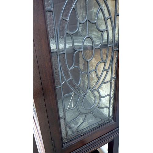 840 - An Edwardian mahogany display cabinet with leaded glass doors. 138cm wide.