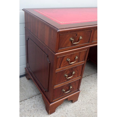 852 - A J Sydney Smith reproduction mahogany pedestal desk with red leather inset top. 122cm wide.