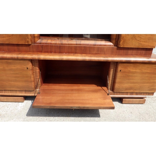 859 - A 1930's continental walnut side cabinet, with sliding glass doors, Epstein style. (200cm wide)