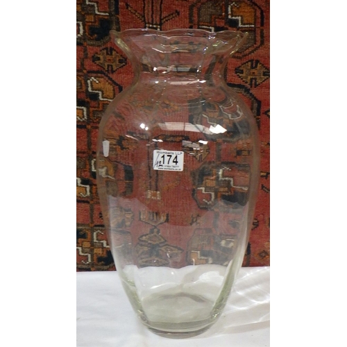 174 - Twelve matching glass vases, each 46cm tall