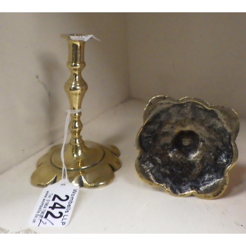 242 - A pair of miniature brass candlesticks