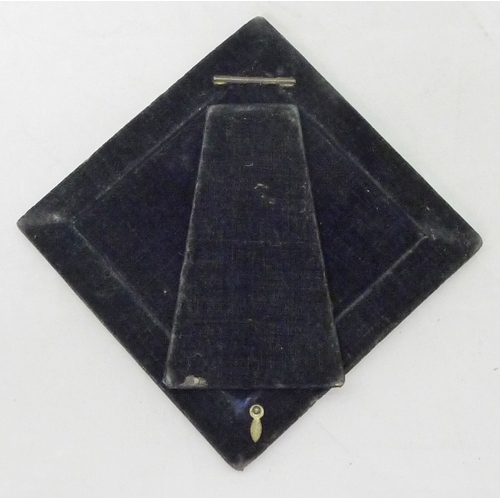 410 - A lozenge shaped photograph frame comprising a velvet ground with pierced silver decorative panel ar... 