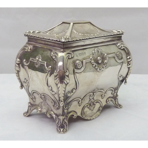 418 - A silver tea caddy of bombe form having Rococo influence decoration, Chester 1907, sponsors mark rub... 