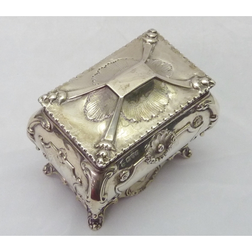 418 - A silver tea caddy of bombe form having Rococo influence decoration, Chester 1907, sponsors mark rub... 