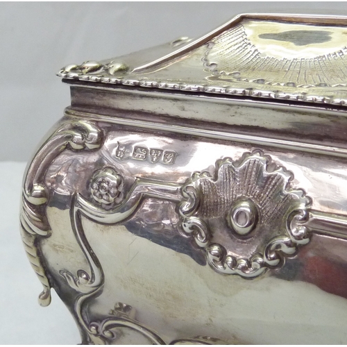 418 - A silver tea caddy of bombe form having Rococo influence decoration, Chester 1907, sponsors mark rub... 