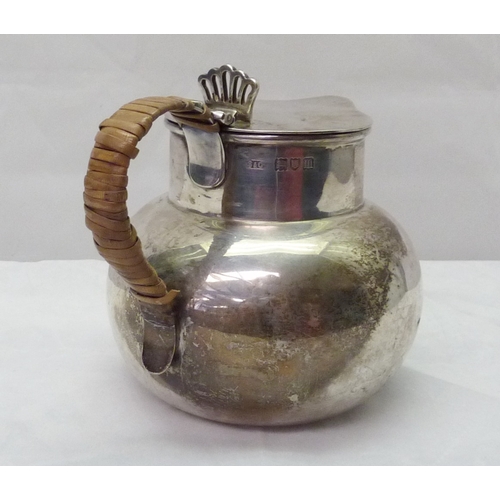 419 - A silver jug having a cane wrapped handle and hinged lid, early 20th cent.  A/F binding damaged, den... 