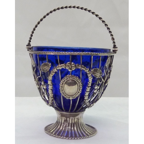 422 - A Victorian silver swing handled pedestal sugar basin, the wirework body decorated with swags, grape... 