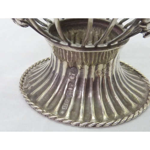 422 - A Victorian silver swing handled pedestal sugar basin, the wirework body decorated with swags, grape... 