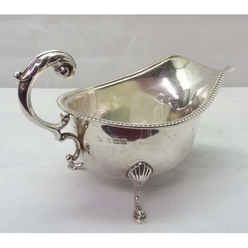 425 - Two silver sauce boats, both standing on hoof feet, early 20th cent.  Larger sauce boat 180mm long /... 