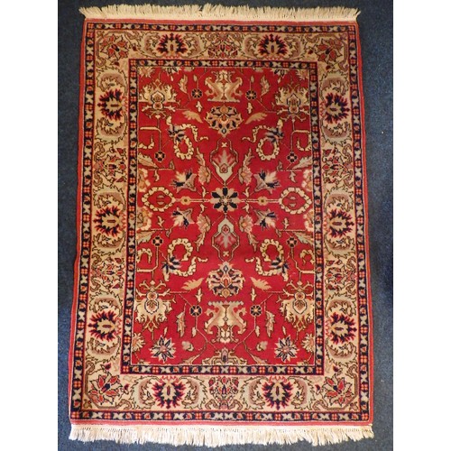 883 - A red ground rug 140 x 99cm