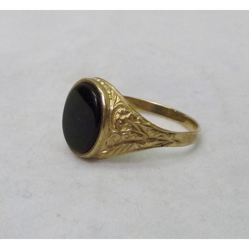 373 - A 9ct gold signet ring set with an oval onyx stone.  3gr gross