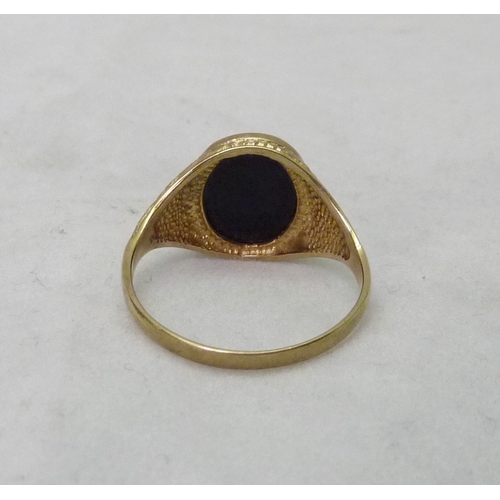 373 - A 9ct gold signet ring set with an oval onyx stone.  3gr gross