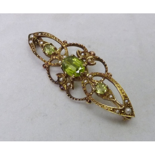 376 - A brooch comprising three green stones and sixteen seed pearls in an openwork 