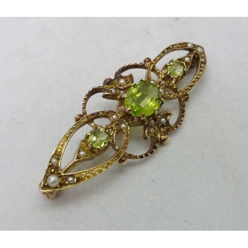 376 - A brooch comprising three green stones and sixteen seed pearls in an openwork 