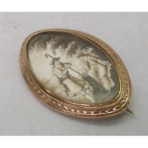 378 - A Georgian brooch comprising a sepia pastoral miniature depicting a shepherd and lady with a hairwor... 