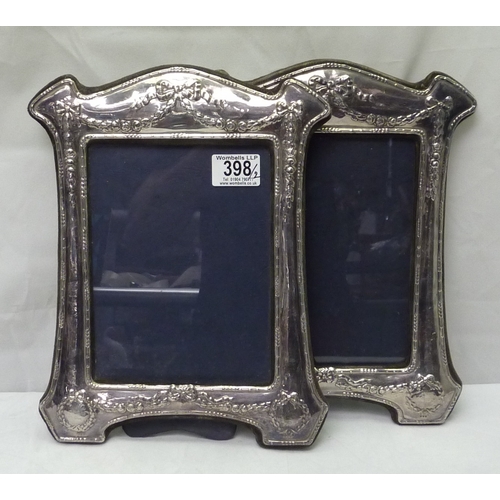 398 - A pair of Britannia silver photograph frames in Edwardian manner, RBB London 1987.  310mm tall / 195... 