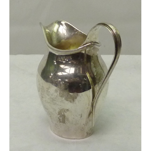 407 - A silver cream jug bearing an applied crest of the Worshipful Company of Cutlers, 20th cent, marks r... 