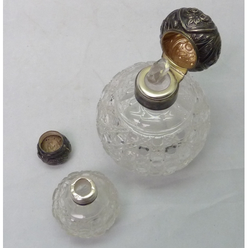 411 - Two silver topped cut glass scent bottles, larger 130mm tall.