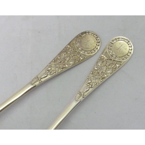 431 - A pair of Victorian silver serving spoons decorated with a registered cast Jacobethan design incorpo... 