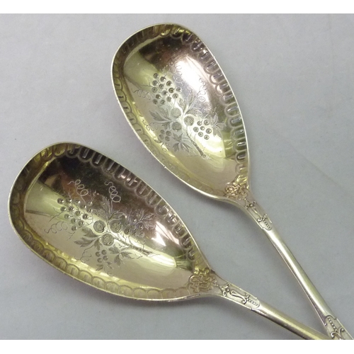 431 - A pair of Victorian silver serving spoons decorated with a registered cast Jacobethan design incorpo... 