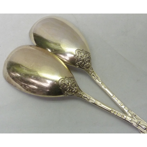 431 - A pair of Victorian silver serving spoons decorated with a registered cast Jacobethan design incorpo... 