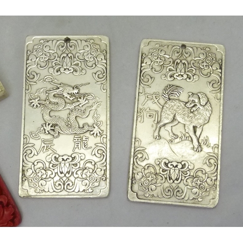 435 - Two Chinese Zodiac interest ingots; a collection of oriental trinkets incl a puzzle box, some cast r... 